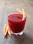A glass of beetroot juice with carrots