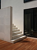 Minimalistisches Treppenhaus mit hellen Holzdielen und einer weissen Steintreppe