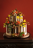 Autumnal wedding torte decorated with leaves and nuts