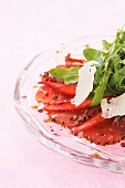 Beef and strawberry carpaccio with pink peppercorns, rocket and parmesan