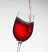 Pouring red wine into a glass