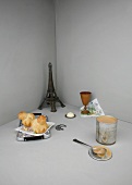An image representing French cuisine, with brioche and a model of the Eiffel Tower