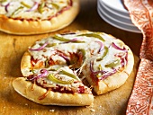 Personal Pizza Topped with Onion and Peppers; Sliced