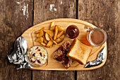 Barbecue Pork Sandwich with Cole Slaw, Steak Fries and a Glass Mug of Beer; All on a Pig Platter; From Above