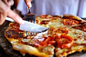 Cheese Pizza Being Sliced