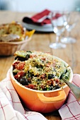 Gratinated fennel with tomatoes, olives and a parsley crust