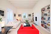 Modern white living room with red chair