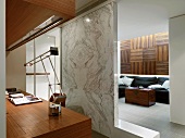 Marble wall dividing home office from living room