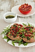 Duck breast with mint sauce, pomegranate seeds and rocket