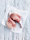 Raw pork chop in butcher paper