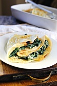 Crepes filled with spinach, ricotta and parmesan cheese