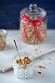 Granola and Yogurt in a Small Glass Jar; Granola in a Glass Canister