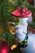 Bauble with dwarf motif hanging from fir branch