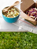 Two Side Salads on an Outdoor Table; Quinoa Salad and Cole Slaw