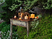 Lit candles on a Rustic Table in the Garden