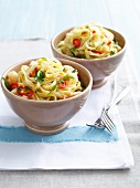 Bowls of pasta with prawns