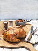 Roast chicken with tapenade on a chopping board