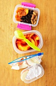 A healthy lunchbox filled with fruit, yogurt and dried fruit