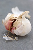 An opened garlic bulb on a slate surface
