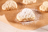 Dusting heart-shaped biscuits with icing sugar