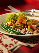 Chicken with fruit on a bed of rice with green beans
