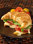 A croissant filled with salami and fontina cheese