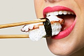 A woman eating sushi