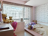 Modern child's room with a bed in front of a window with a see-through curtain