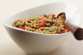 Bowl of Brown Rice with Cherry Tomatoes, Green Pepper and Pistachios
