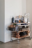 Well stocked serving trolley with champagne bottles, wine glasses and cookware
