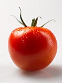 A tomato with drops of water