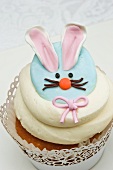 A cupcake decorated with an Easter bunny