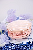 A pink macaroon filled with buttercream