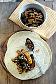 Chicken and bean chili with roasted pumpkin on a tortilla