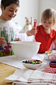 Young boy and girl mixing ingredients for cupcakes in a bowl