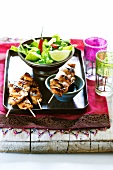 Oriental chicken sate with soy sauce and salad