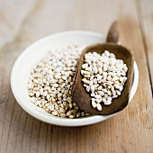 Pearl barley in a bowl and in a scoop