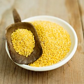 Millet in a bowl and on a scoop