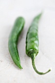 Two green chilli peppers