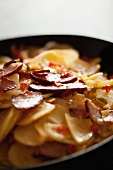 Fried potatoes with bacon and chillis