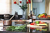Still-life arrangement of vegetables, herbs and wine in kitchen (Villa Octavius, Lefkas, Greece)