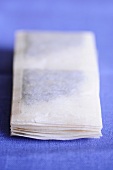 A stack of square tea bags
