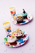 Colourful cupcakes and orange juice for a child's birthday party