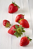 Fresh strawberries on a white wooden surface