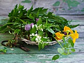 Fresh herbs with flowers in a wicker basket