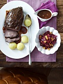 Marinated pot roast with raisin sauce, dumplings and red cabbage salad