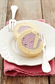 Two slices of sponge roll with blueberry cream