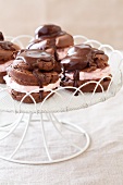 Chocolate Puff Pastries with a Strawberry Cream Filling on a Pedestal Dish