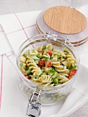 Pasta salad with vegetables in a jar for a picnic