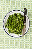 Freshly chopped coriander on a plate with a knife